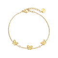Edelstahlarmband in gold mit drei Schmetterlingen und Zirkon-Steinen, 17+3cm lang.