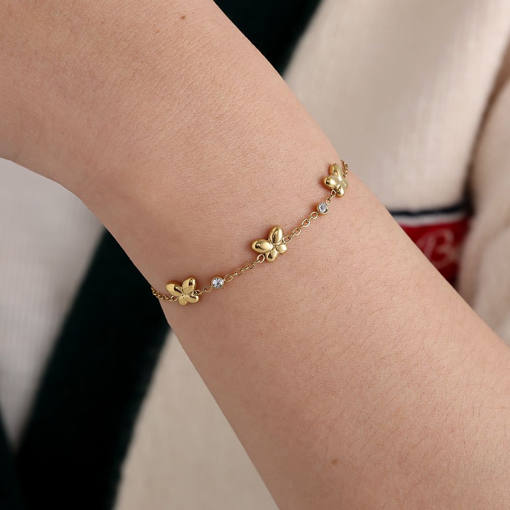 Edelstahlarmband in gold mit drei Schmetterlingen und Zirkon-Steinen, 17+3cm lang.
