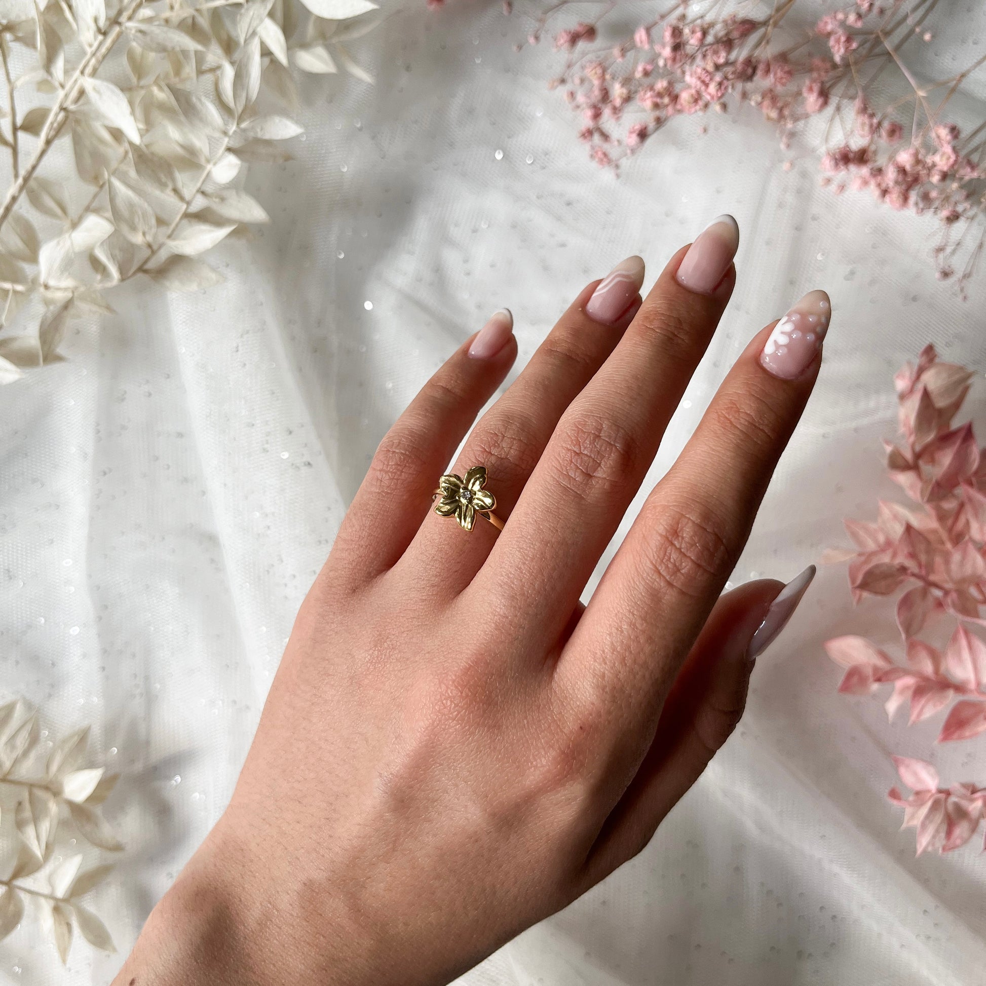 Edelstahlring in gold mit Blume und Zirkon-Stein, größenverstellbar.